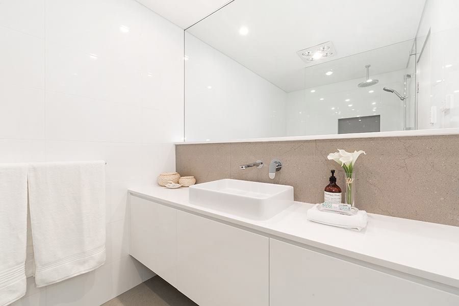 White bathroom vanity with stone basin